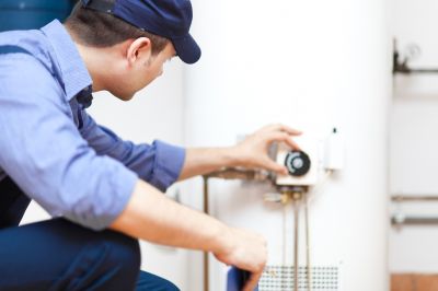 Plumber Working on a Water Heater